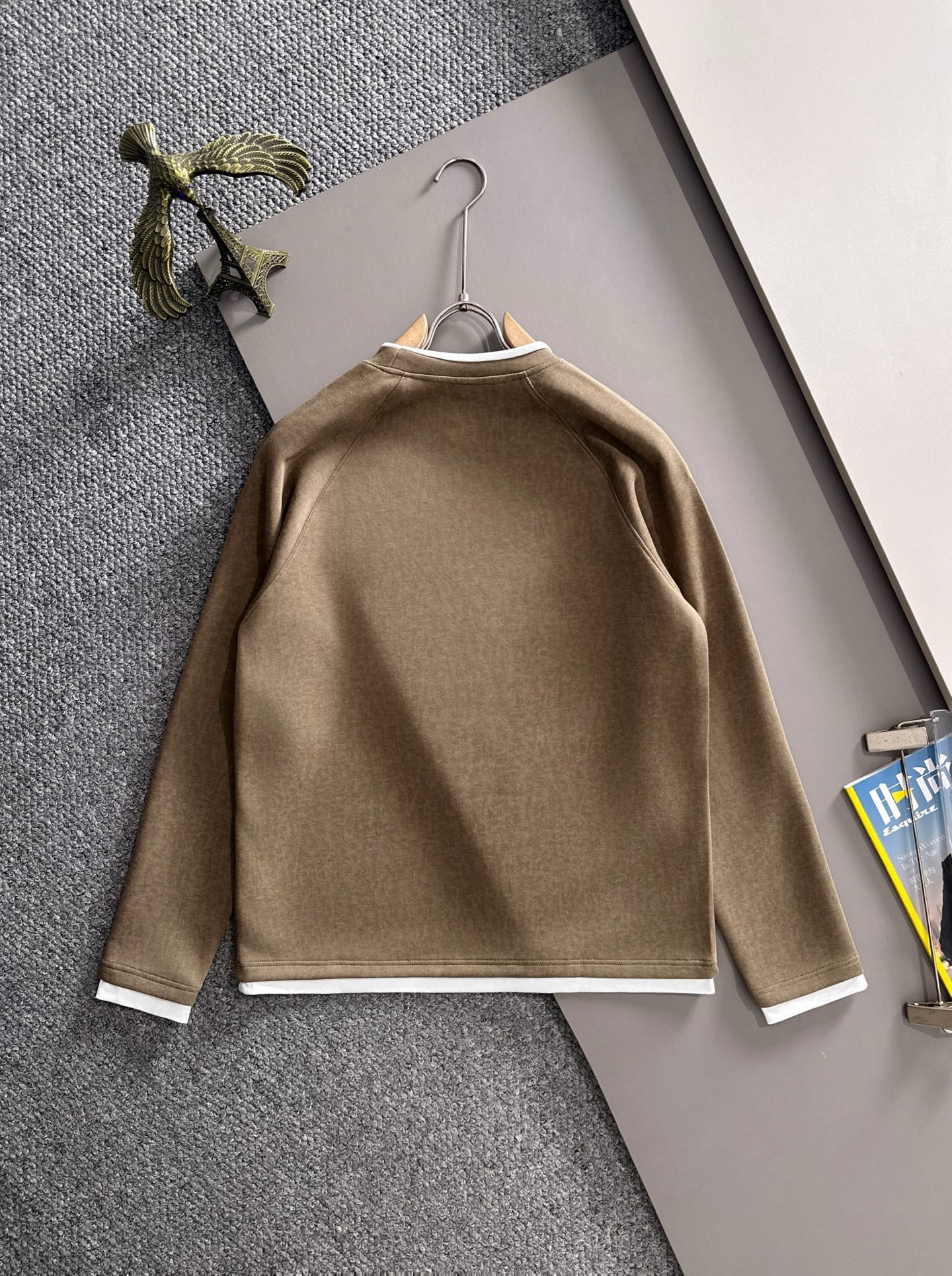 Gucci long-sleeve top on hanger with crew neck, white cuffs, and chest logo
