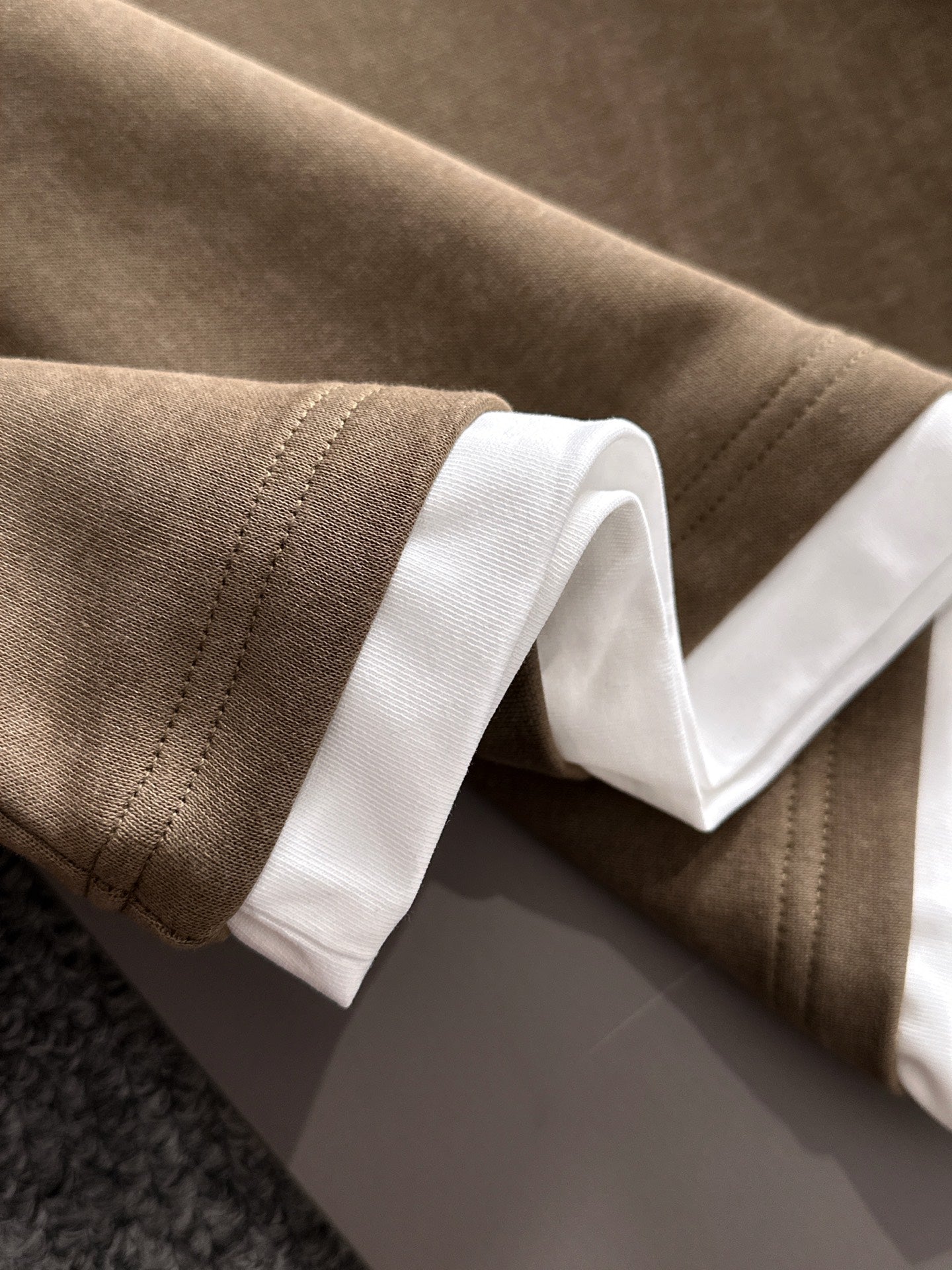 Gucci long-sleeve top cuff detail with white ribbed trim on soft brown fabric
