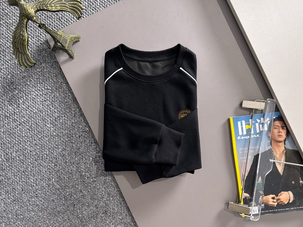 Black long-sleeve sweatshirt on hanger with crew neck and gold crest logo