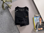 Black long-sleeve sweatshirt on hanger with crew neck and gold crest logo