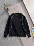 Black long-sleeve sweatshirt with white piping and small gold logo emblem