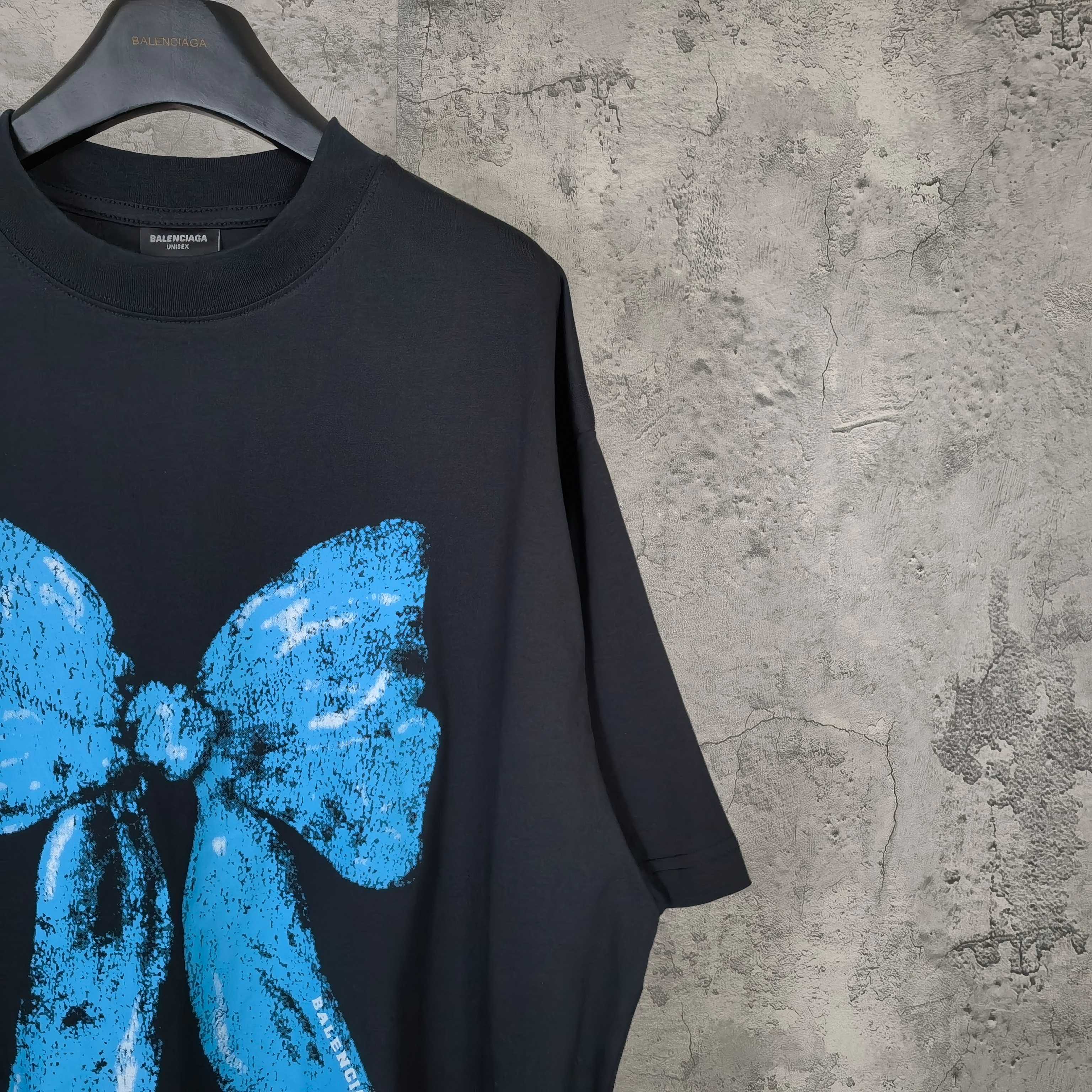 Balenciaga black T-shirt close-up of blue bow print on front