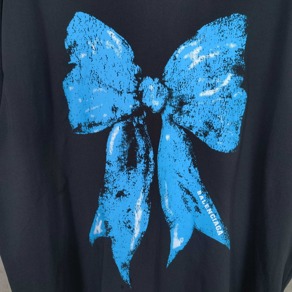 Balenciaga black T-shirt close-up of blue bow graphic