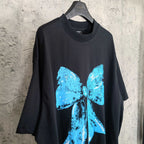 Balenciaga black T-shirt with blue bow graphic, three-quarter front view