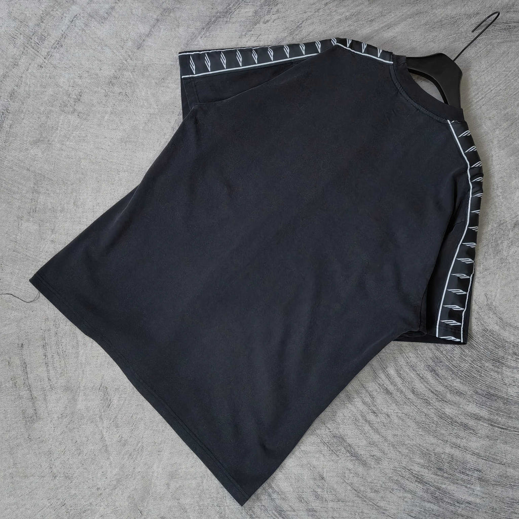 Balenciaga short-sleeve T-shirt flat lay, dark top with contrast striped sleeve trim
