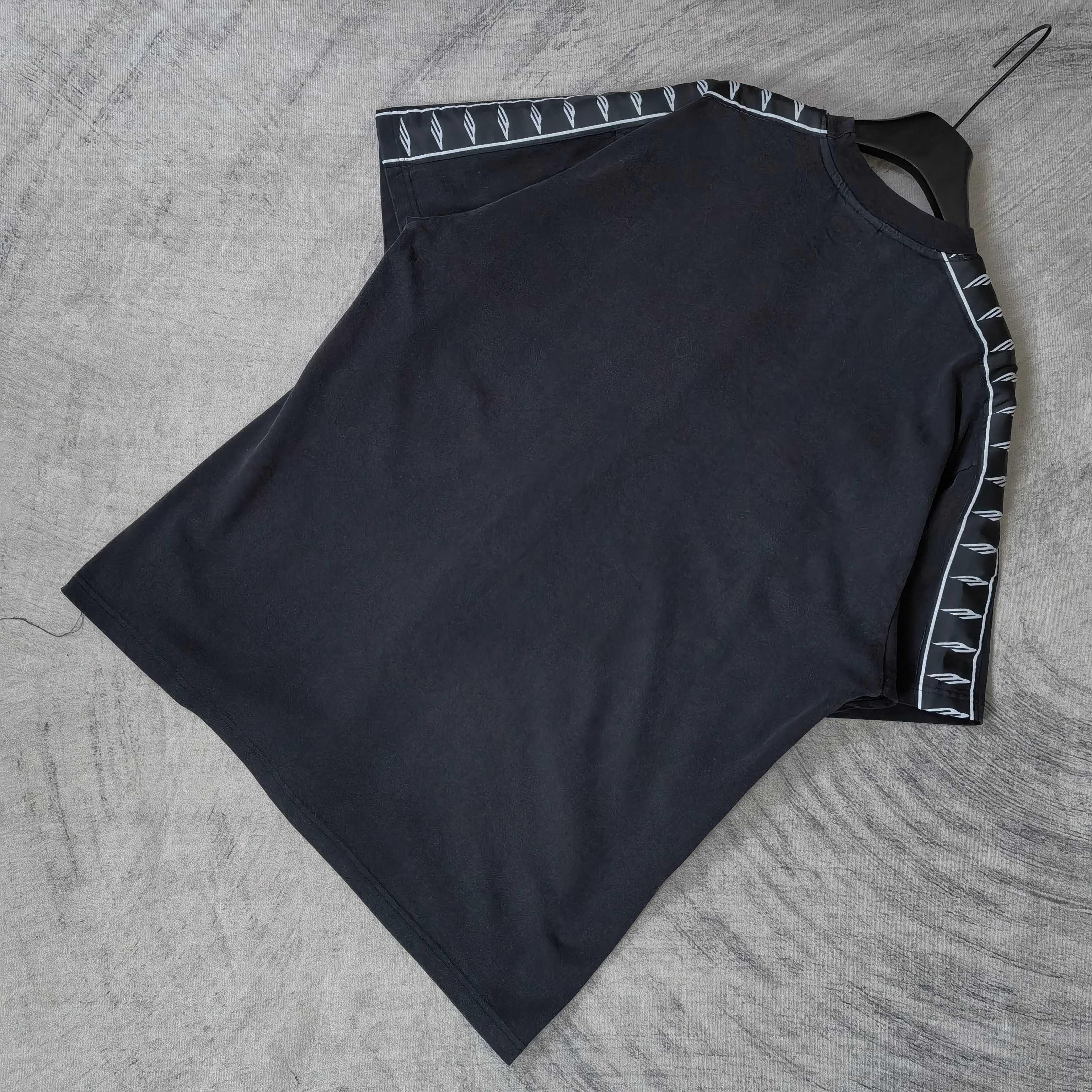Balenciaga short-sleeve T-shirt flat lay, dark top with contrast striped sleeve trim