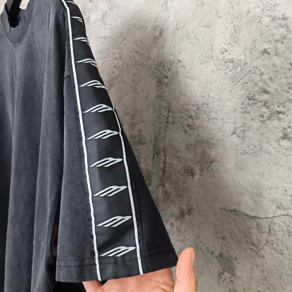Balenciaga short-sleeve T-shirt sleeve detail, dark fabric with white contrast stripe