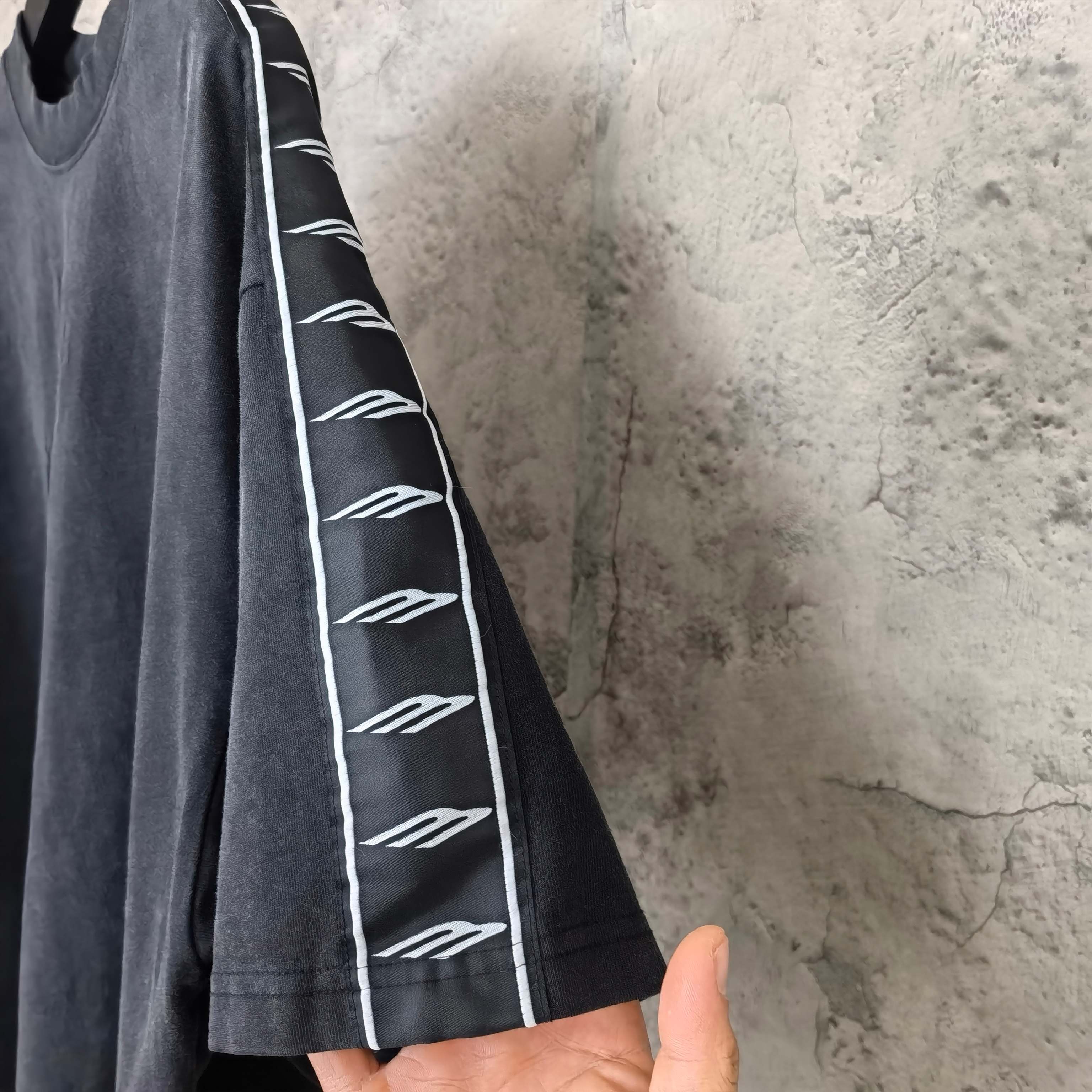 Balenciaga short-sleeve T-shirt sleeve detail, dark fabric with white contrast stripe