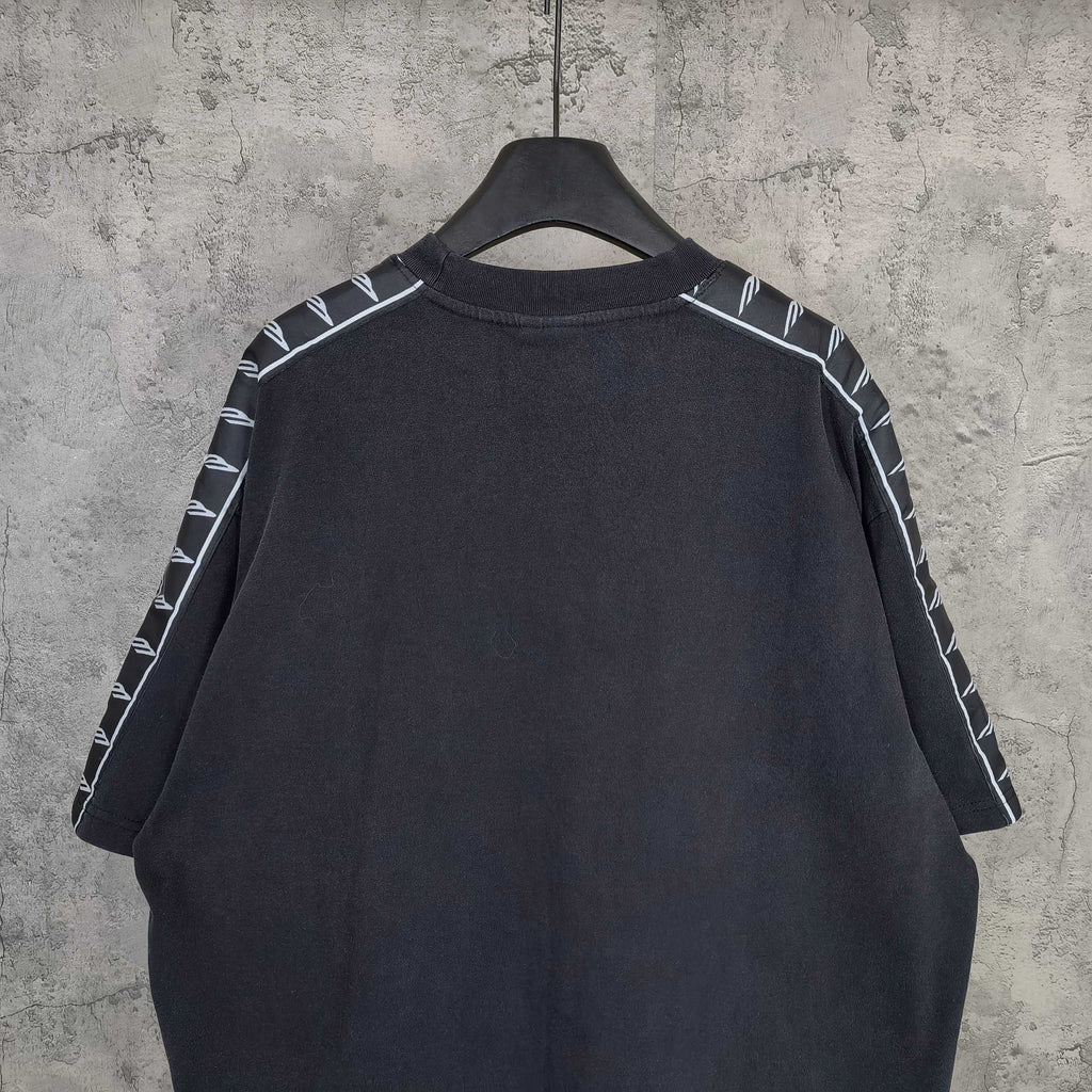 Balenciaga short-sleeve T-shirt back view, dark with contrast striped sleeve details