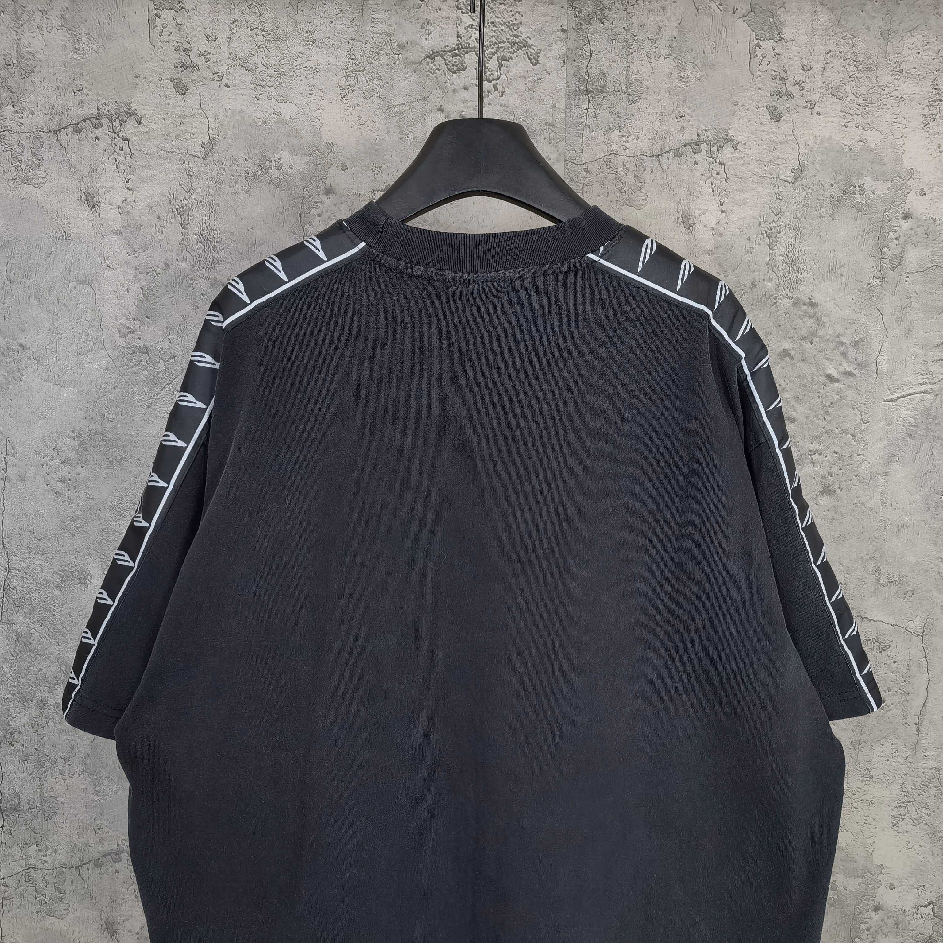Balenciaga short-sleeve T-shirt back view, dark with contrast striped sleeve details