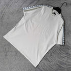 Balenciaga white short-sleeve T-shirt laid flat, patterned stripe trim at sleeves
