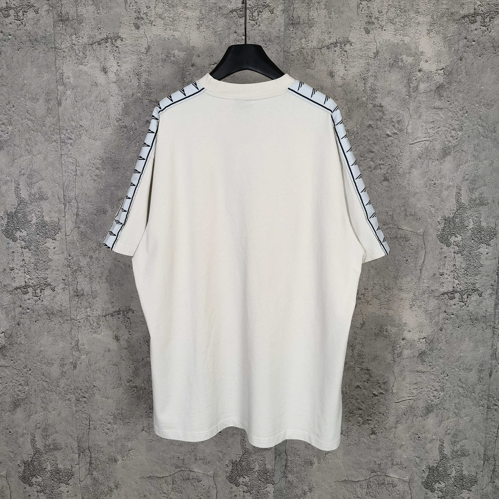 Balenciaga white crewneck T-shirt, back view, with patterned stripe sleeve trim