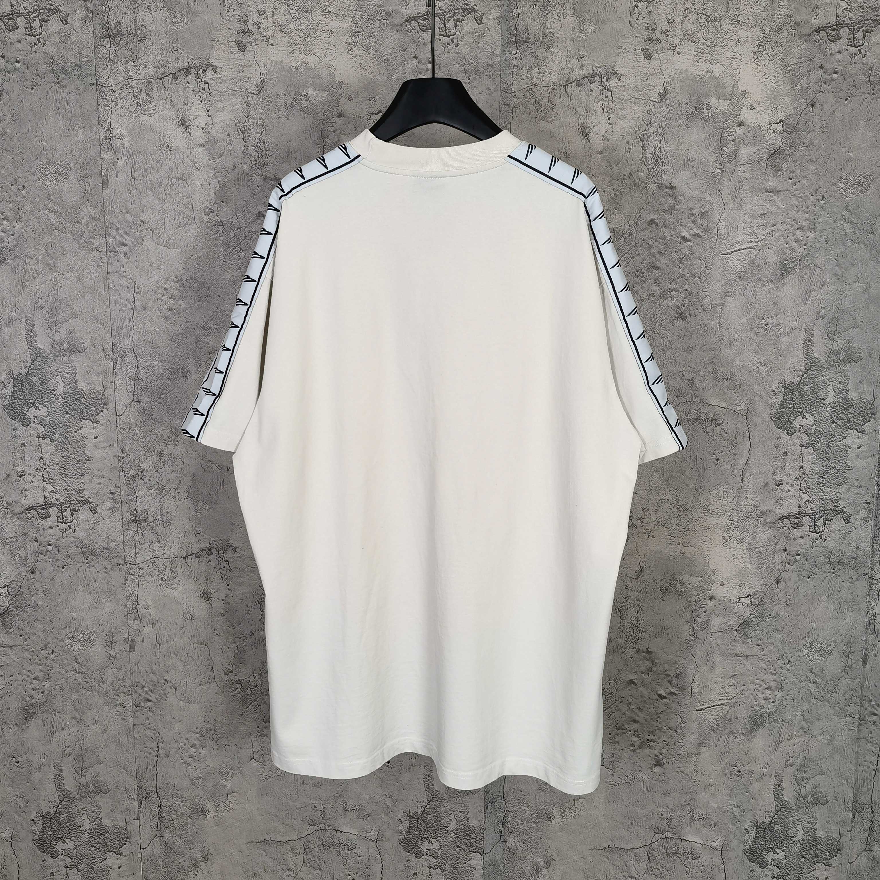 Balenciaga white crewneck T-shirt, back view, with patterned stripe sleeve trim