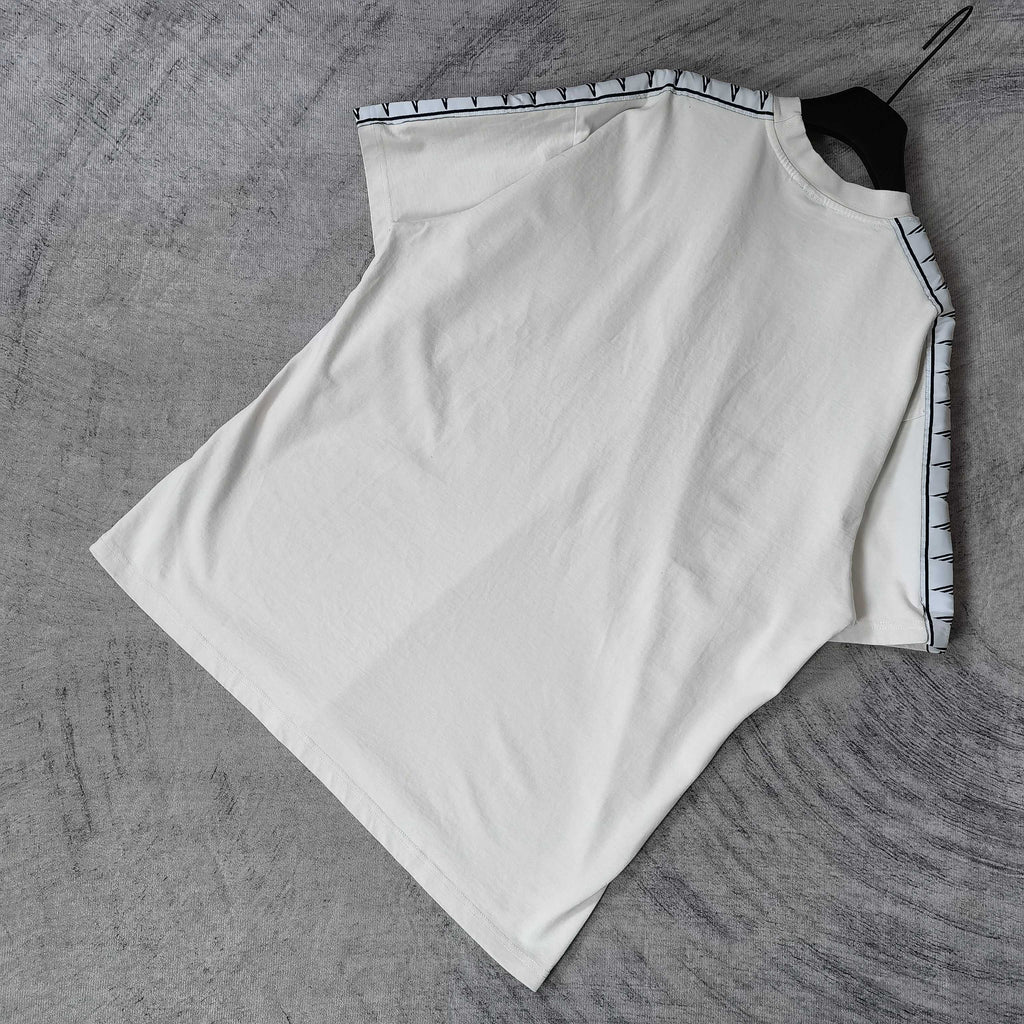 Balenciaga white short-sleeve T-shirt flat lay, patterned stripe trim along sleeves
