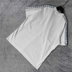 Balenciaga white short-sleeve T-shirt flat lay, patterned stripe trim along sleeves