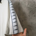 Balenciaga white T-shirt sleeve with black patterned stripe trim