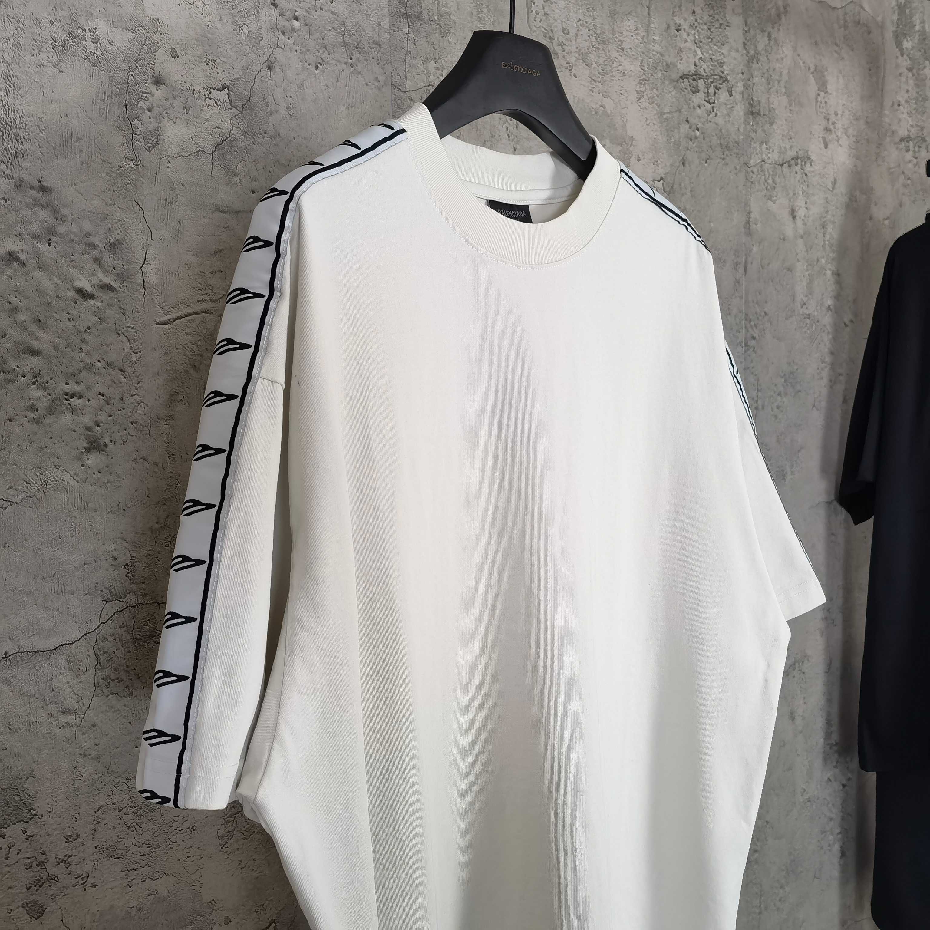 Balenciaga white crewneck T-shirt with patterned stripe trim on sleeves, side view