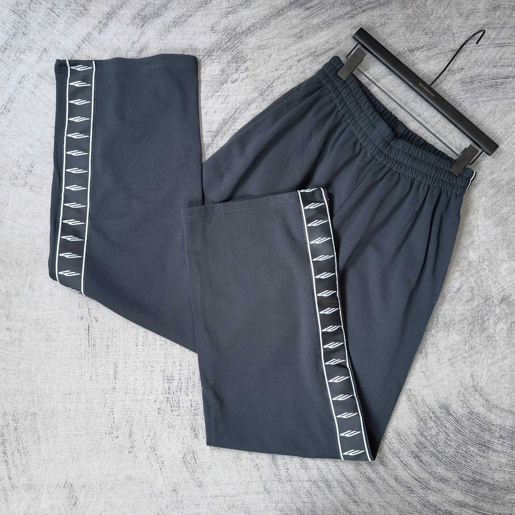 Balenciaga pants set: solid dark pair and side-stripe pair with white logo tape