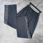 Balenciaga pants set: solid dark pair and side-stripe pair with white logo tape