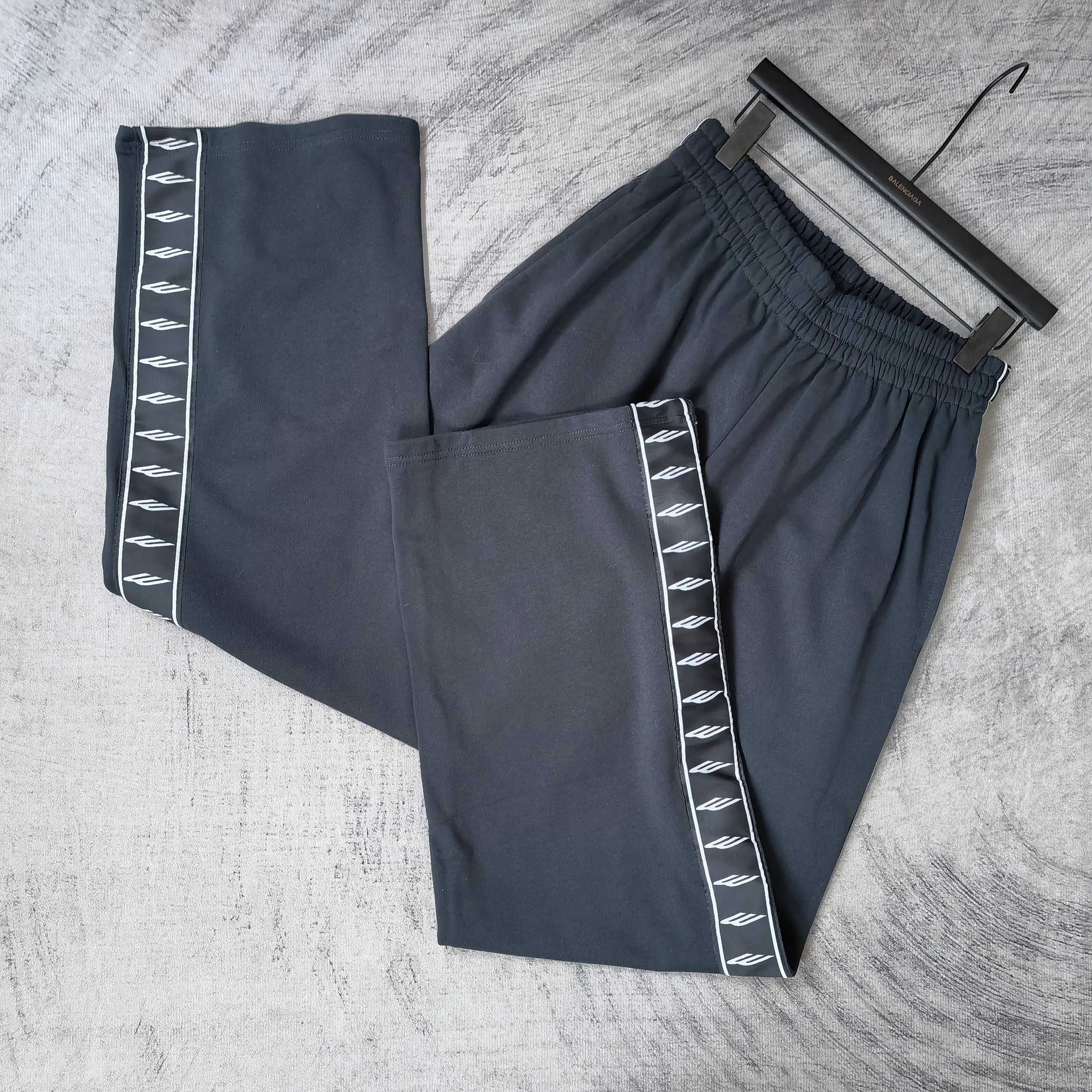 Balenciaga pants set: solid dark pair and side-stripe pair with white logo tape