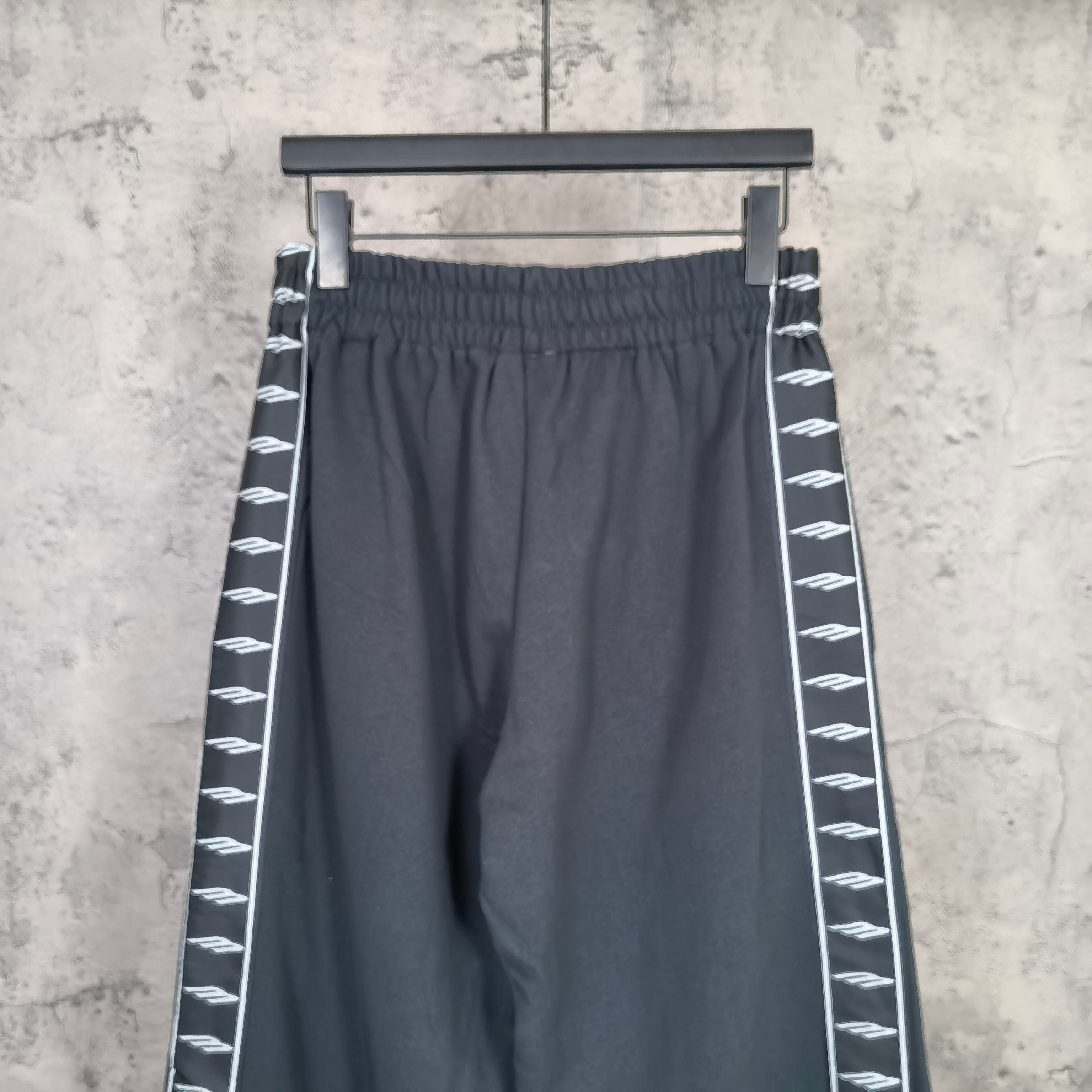 Balenciaga elastic-waist wide-leg pants with white patterned stripe along side seam