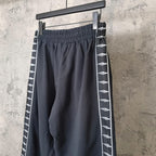 Balenciaga wide-leg pants with elastic waistband and white patterned side stripe