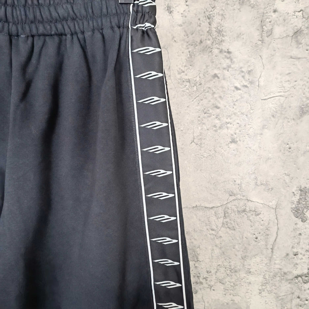 Balenciaga elastic-waist pants close-up with white patterned side stripe
