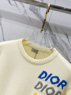 Cream knit sweater close-up of crew neckline and blue multicolor "DIOR" logo text