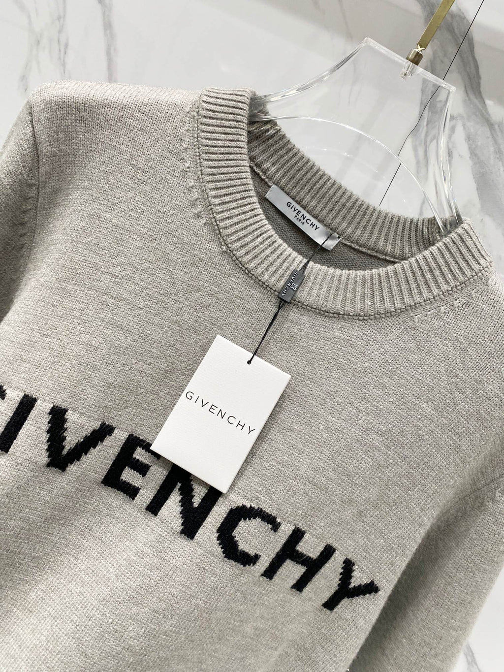 Givenchy crewneck sweatshirt with hanging white brand tag and black GIVENCHY print