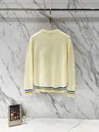 Long-sleeve sweater in cream knit with ribbed hem and striped cuffs; back view