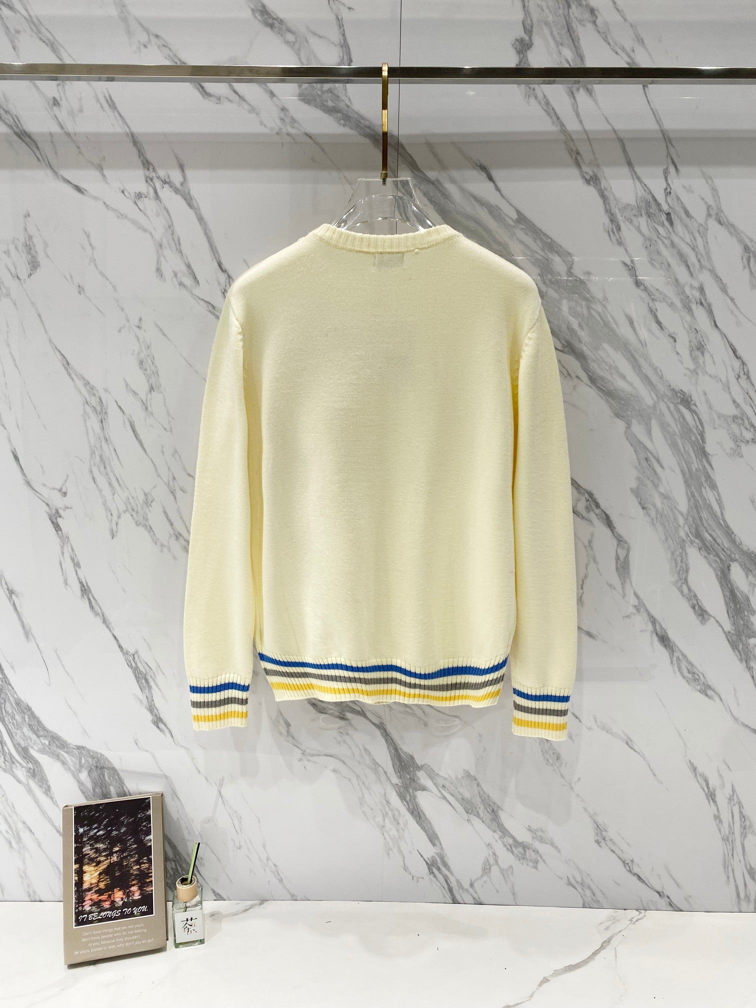 Long-sleeve sweater in cream knit with ribbed hem and striped cuffs; back view