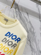 Cream knit sweater close-up of multicolor "DIOR" lettering across the chest