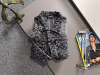 Distressed denim jacket on hangers with button front and chest flap pockets