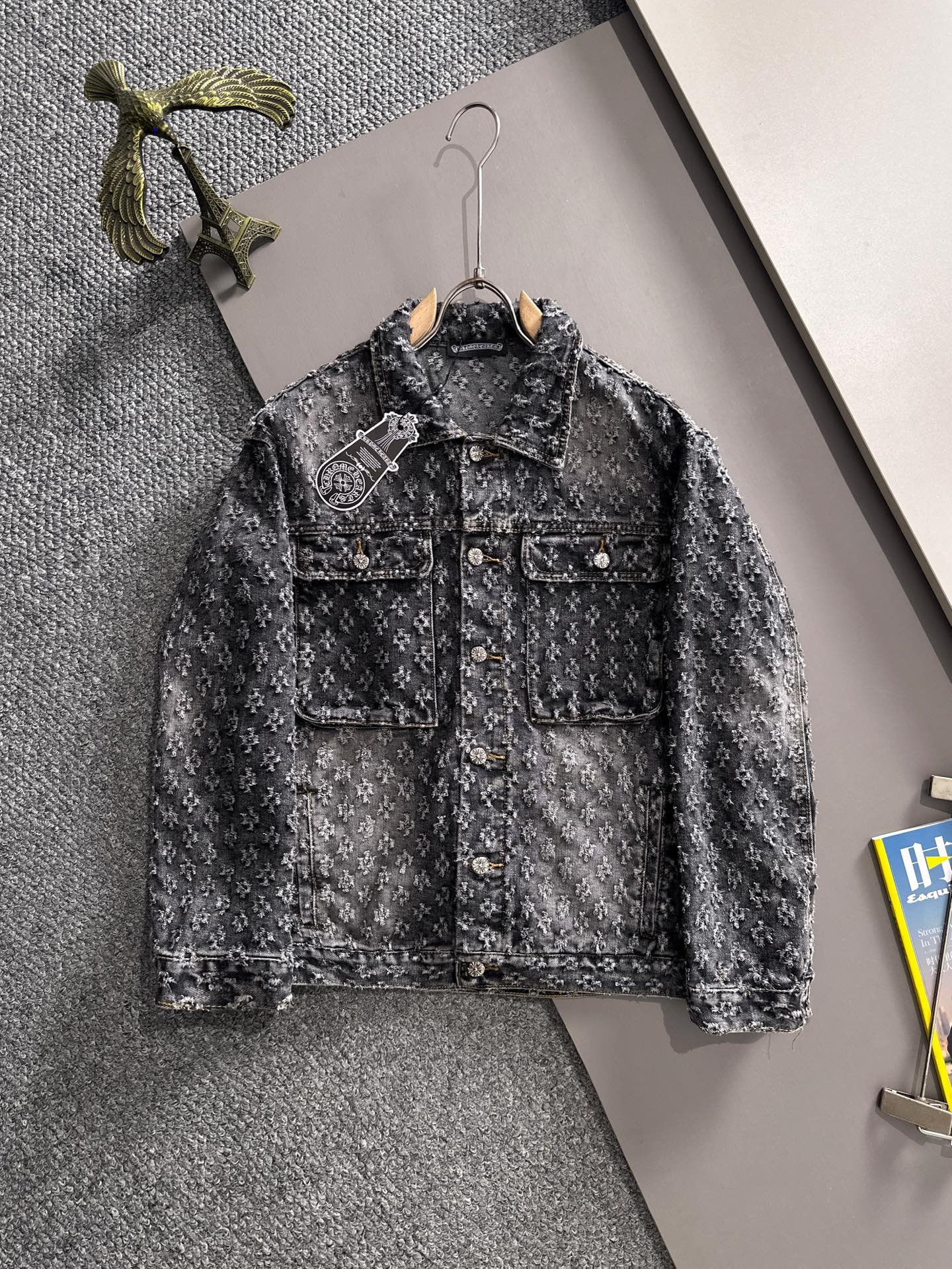 Distressed black denim jacket with button front and chest flap pockets