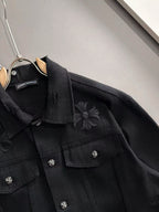 Black denim jacket with embroidered flower details and flap chest pockets
