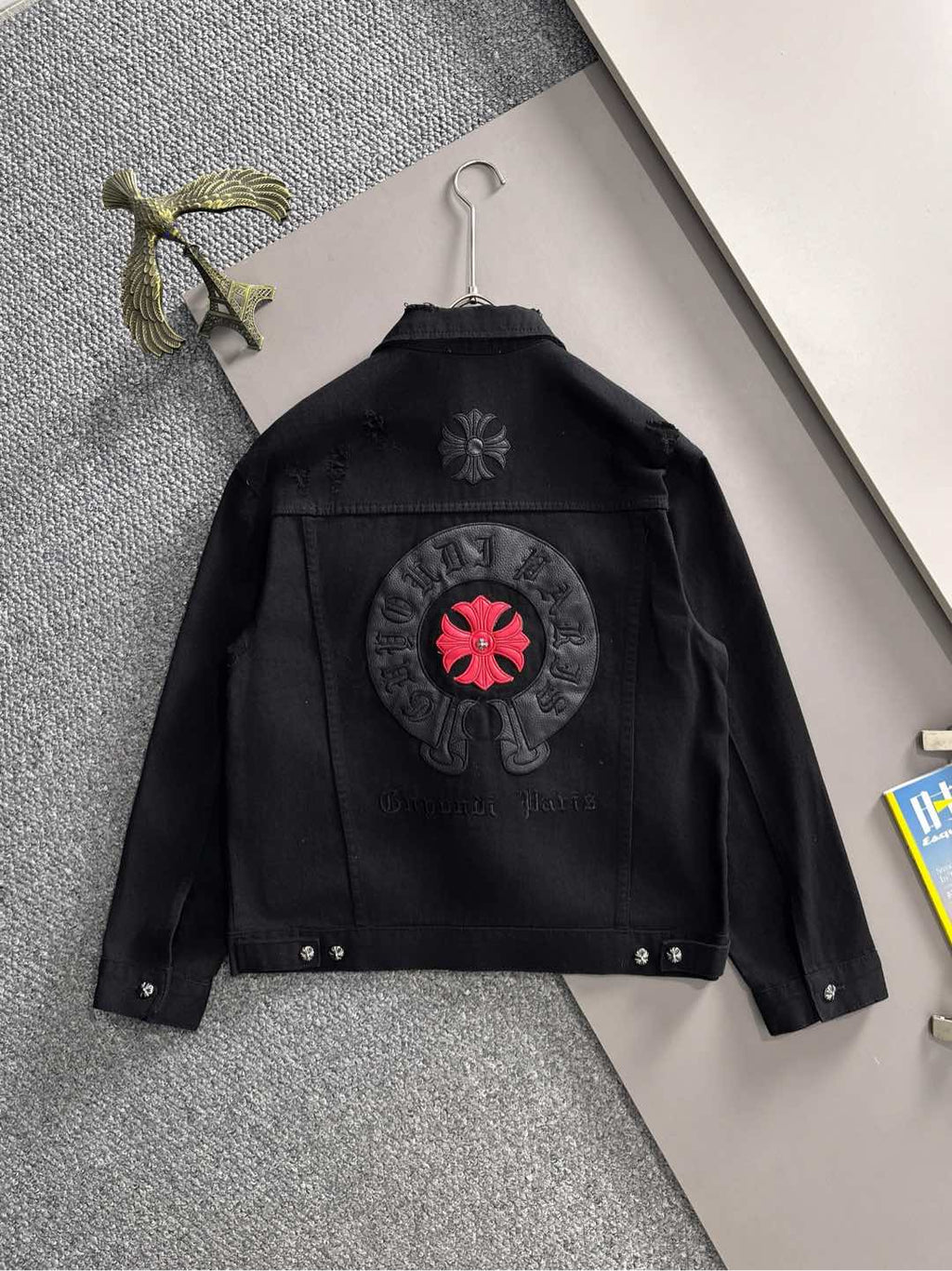 Black denim jacket back patch with red flower emblem in circular embroidery