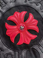Black jacket patch with bright red flower and small silver jewel center