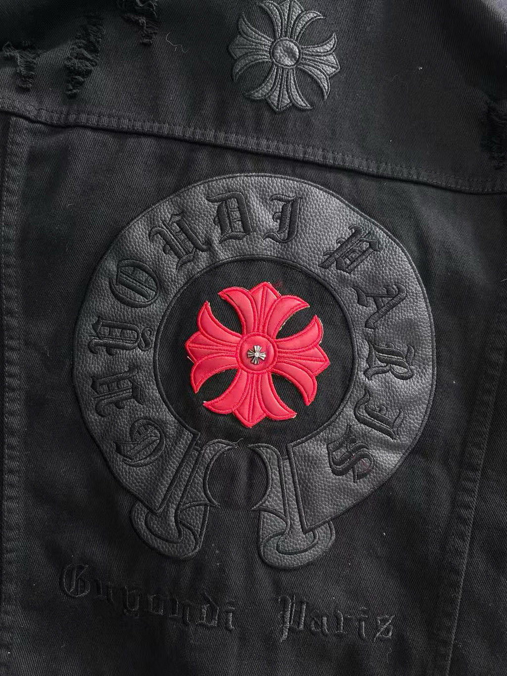 Back circular patch on black denim with red flower and embossed lettering