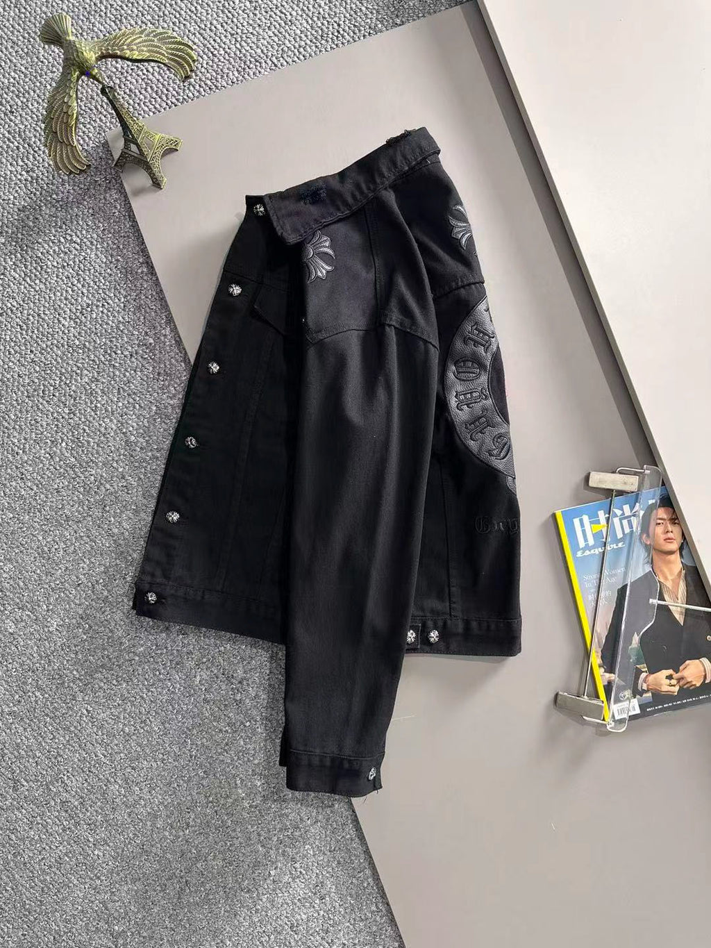 Black long-sleeve denim jacket with large front and sleeve embroidery details