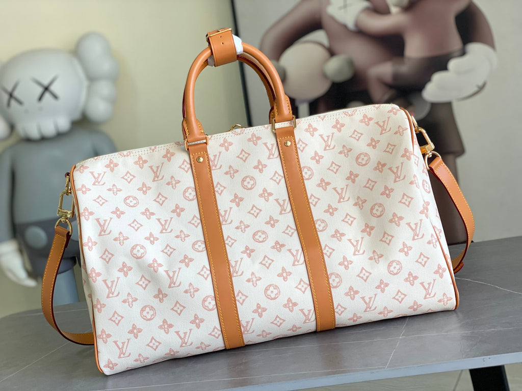 Monogram duffle-style bag with tan handles and crossbody strap, luggage shape