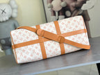 Monogram duffle bag with tan buckle strap and structured sides