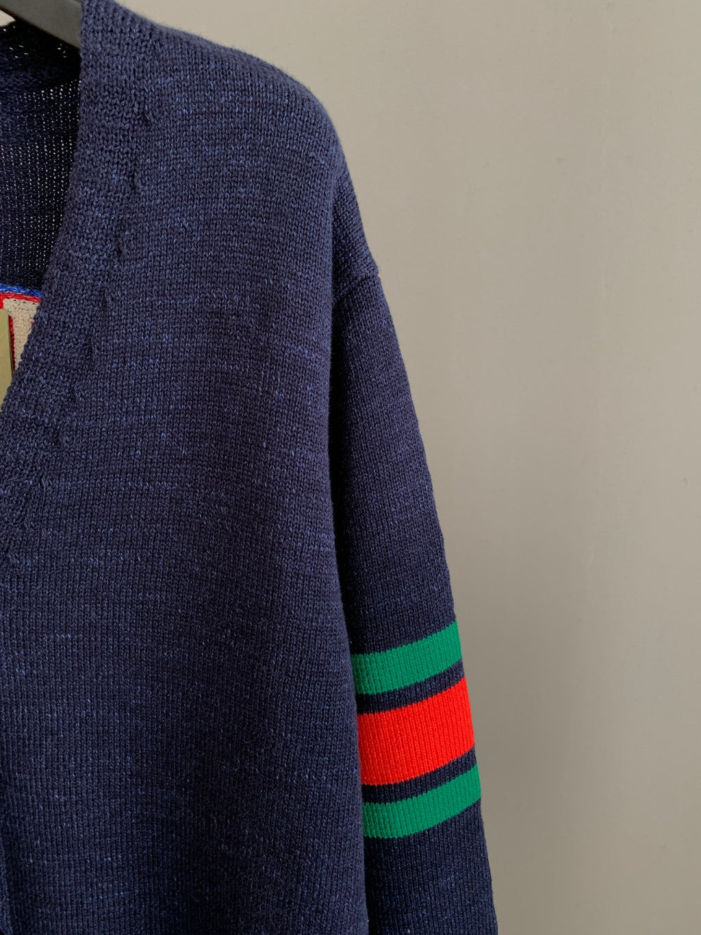 Navy knit cardigan sleeve with green and red striped ribbed cuff