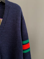 Navy knit cardigan sleeve with green and red striped ribbed cuff