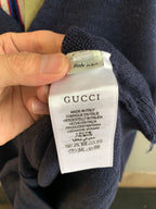 Gucci care label on navy knit cardigan sleeve, Made in Italy