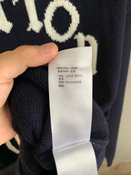 Navy knit sweater fabric composition label: 74% laine wool, 26% polyamide