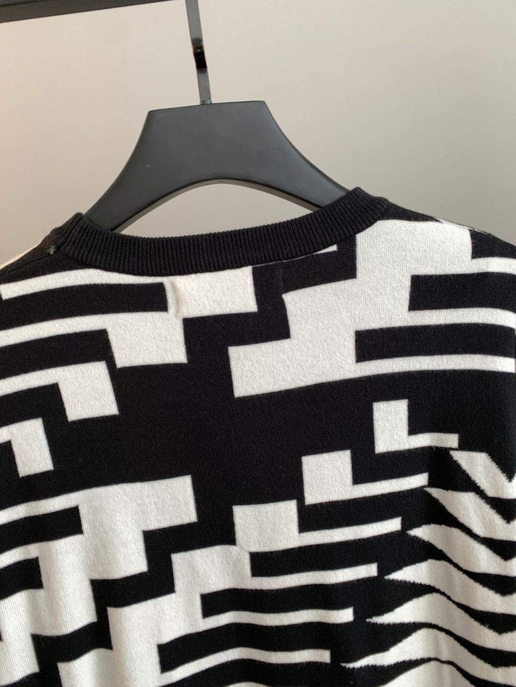 Knit sweater collar and upper chest with black-and-white geometric design