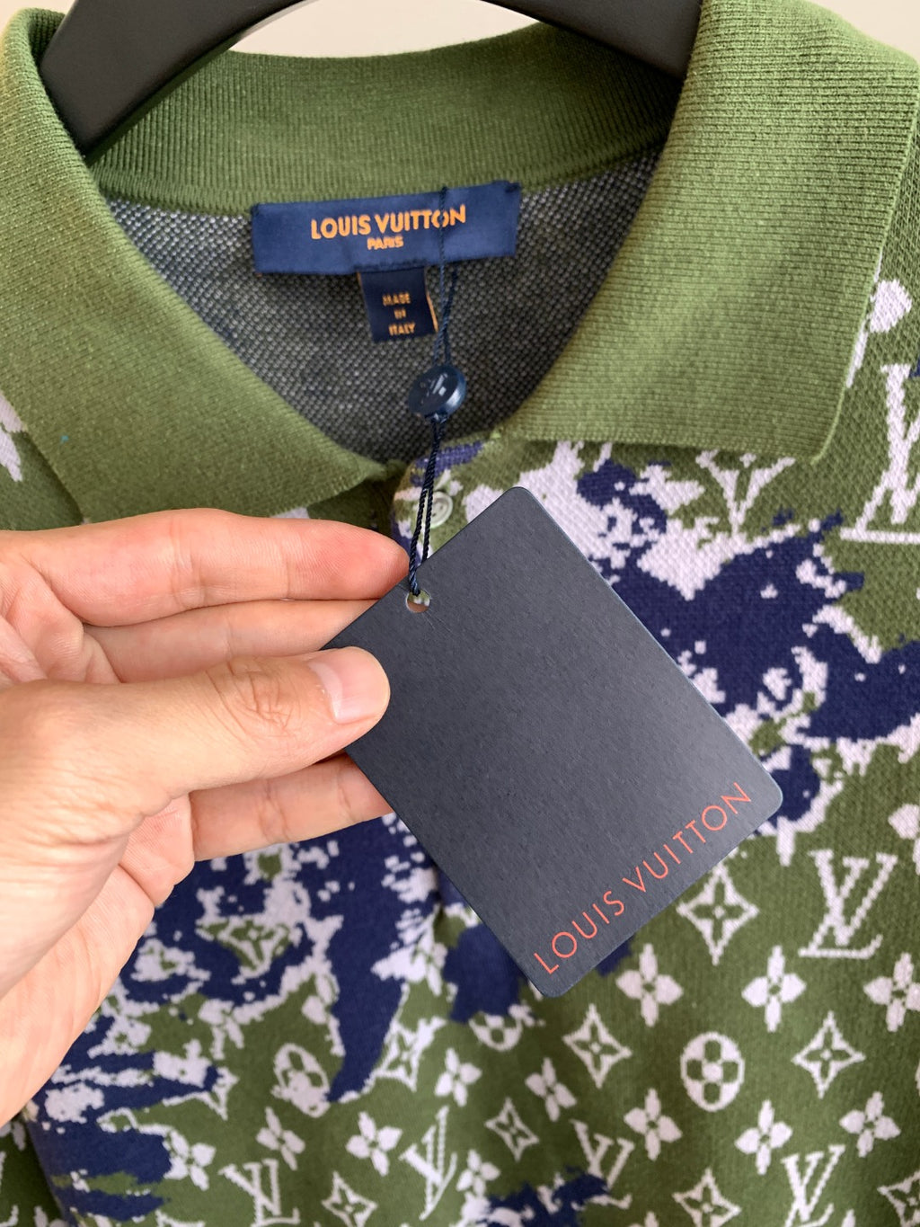 Louis Vuitton sweater care tag attached near collar; green blue white monogram knit