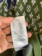 Louis Vuitton size label on green knit sweater showing size codes and values