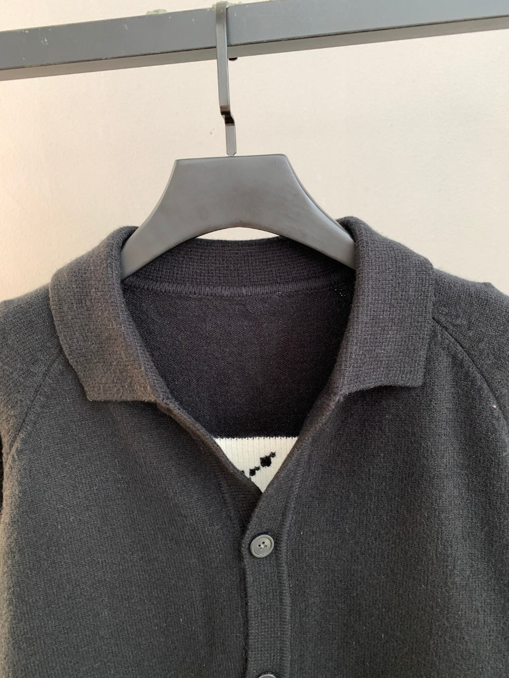 Dark knit cardigan with folded collar and button front