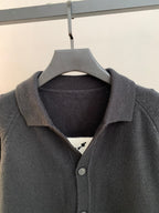 Dark knit cardigan with folded collar and button front